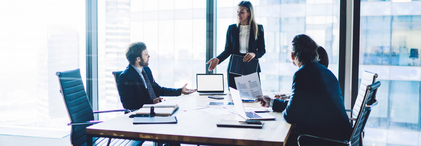 Legal professionals in a business meeting discussing client strategy